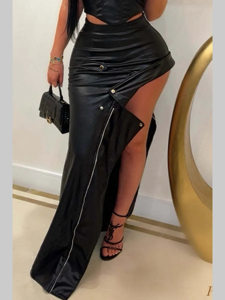 Front view of a black faux leather asymmetrical maxi skirt featuring snap-button detailing and a high slit.