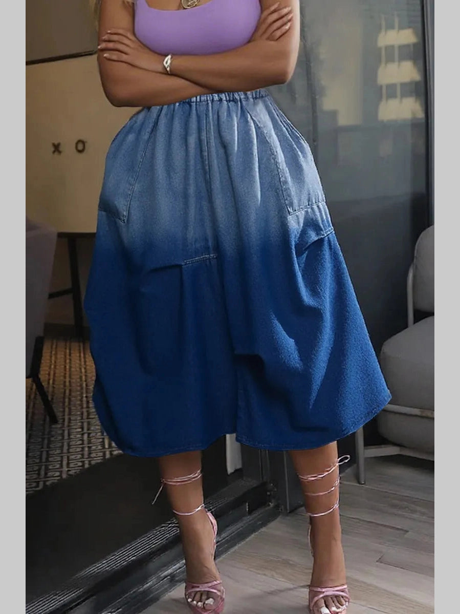 Front view of a women's ombré denim skirt featuring a light-to-dark blue gradient design.