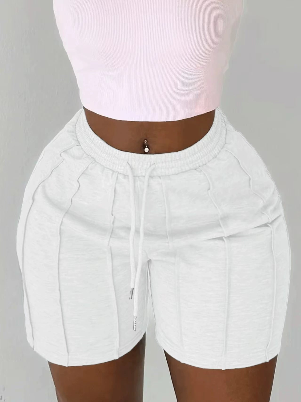 Women's white on the move pleated shorts with slim fit and textured pleated design.