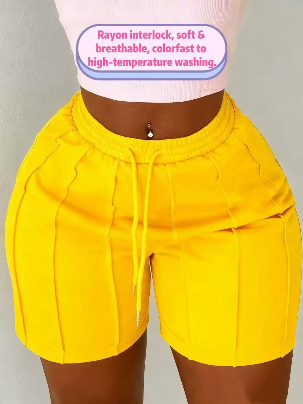Women's yellow on the move pleated shorts with slim fit and textured pleated design.