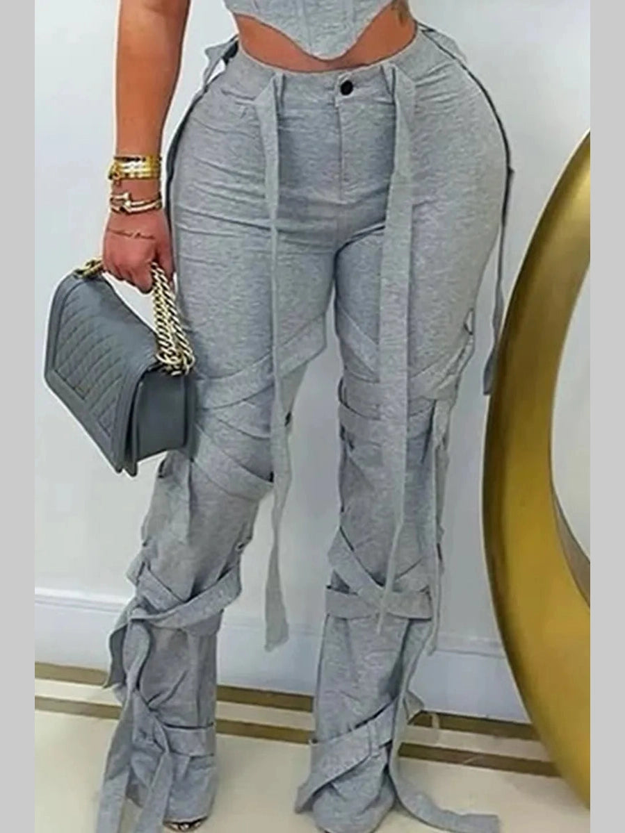 Model wearing grey Rebel Strap Flared Pants with a fitted crop top