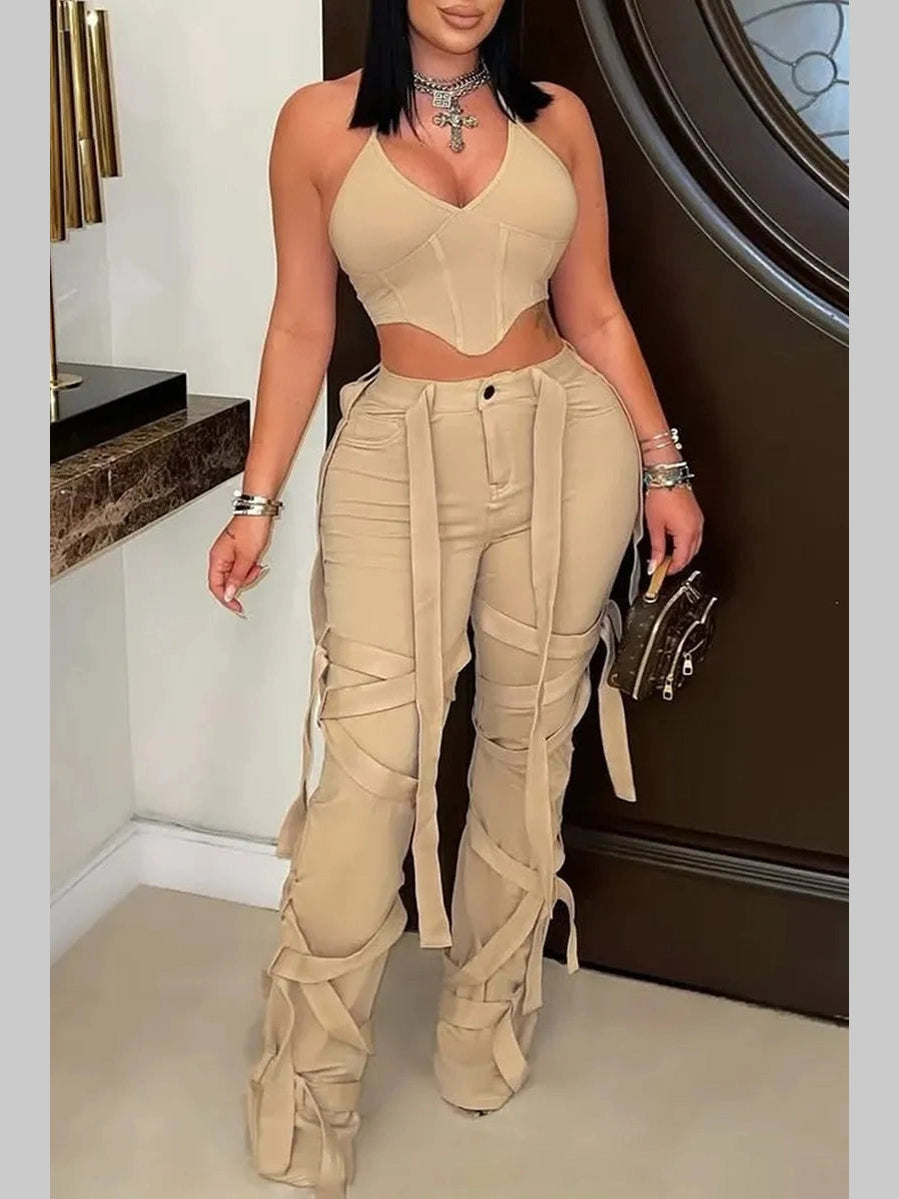 Model wearing khaki Rebel Strap Flared Pants with a fitted crop top