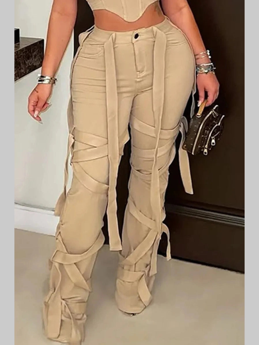 Model wearing khaki Rebel Strap Flared Pants with a fitted crop top