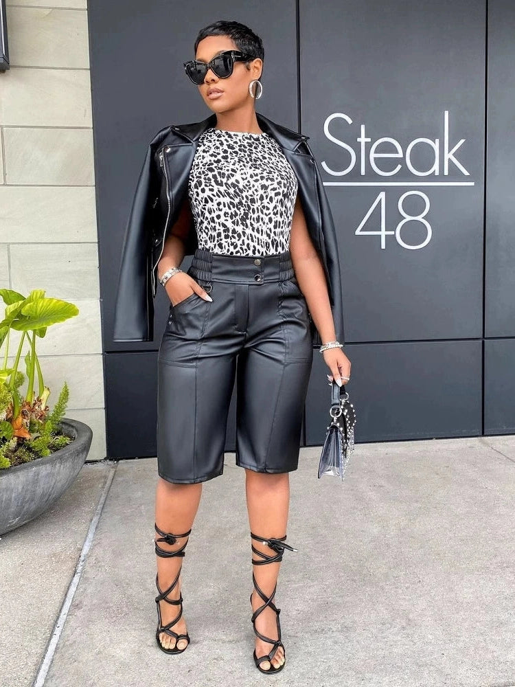 Women's black faux leather longline shorts with a straight-leg fit and below-the-knee length.